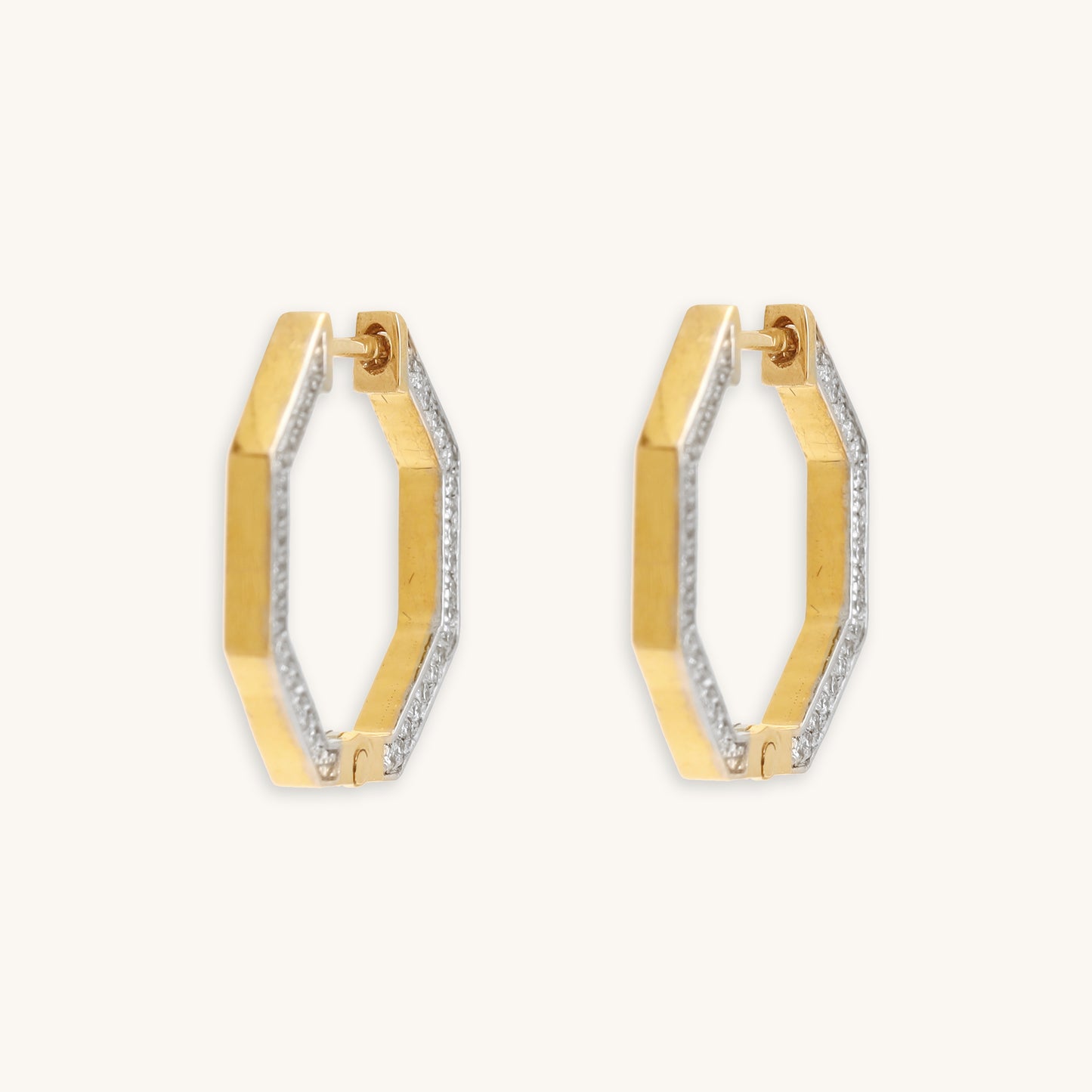 Hexagon diamond earrings crafted with 18 kt gold. Sophisticated daily wear jewellery for women. Elegant everyday diamond earrings. A luxurious classic gift idea for her.