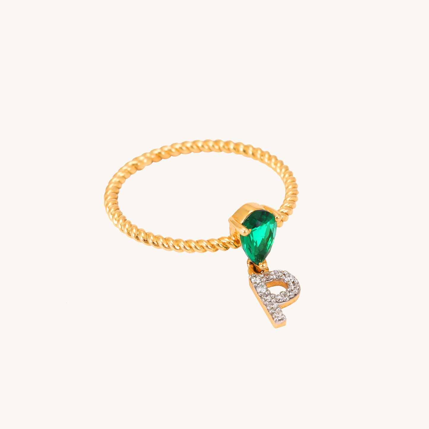 Elevate your look with our stunning 18 kt gold P Drop Ring, featuring a captivating emerald. Priced under 30,000, it's a thoughtful gifting idea for her. Versatile for everyday wear, this ring seamlessly transitions from work to weekend, complementing both casual and formal looks.