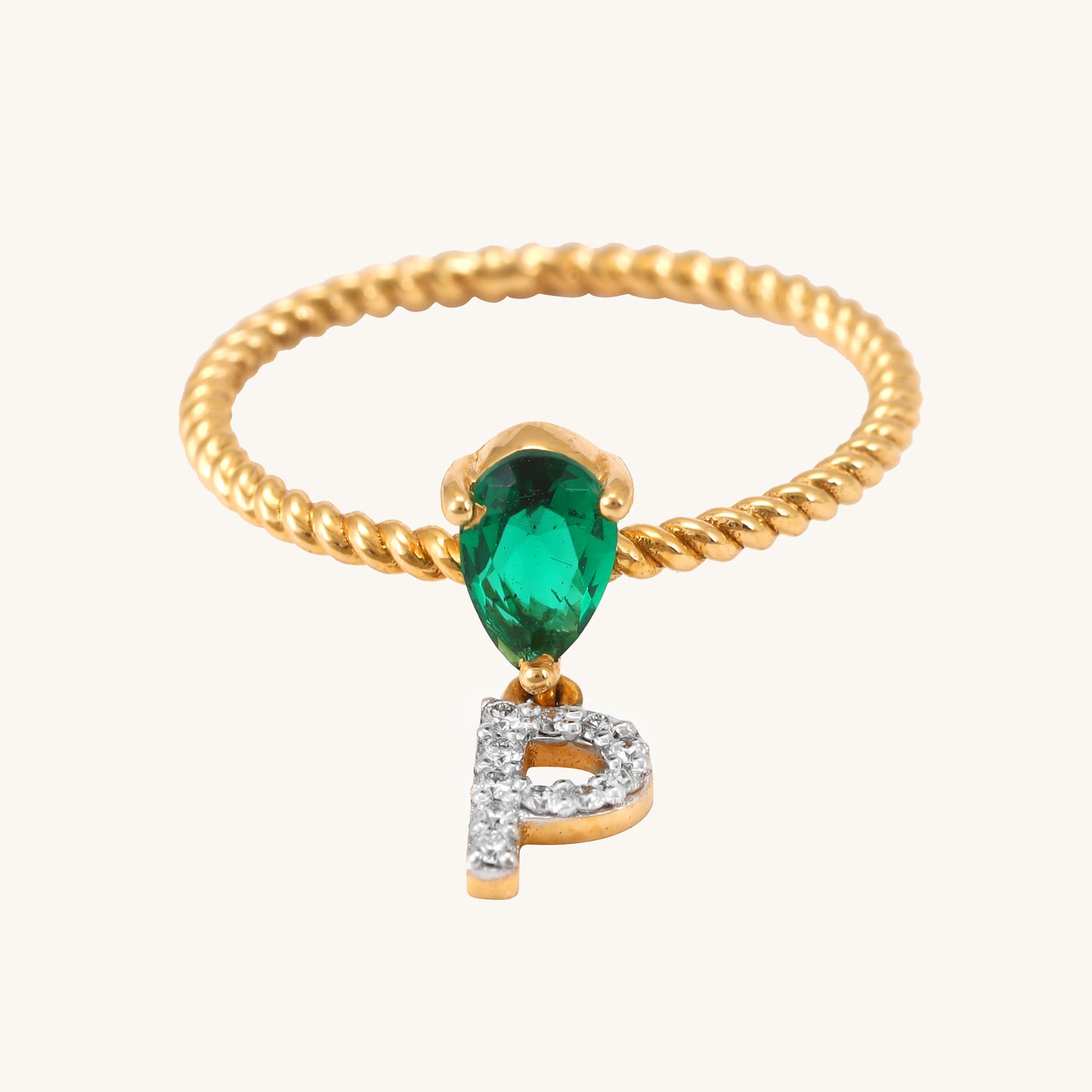Elevate your look with our stunning 18 kt gold P Drop Ring, featuring a captivating emerald. Priced under 30,000, it's a thoughtful gifting idea for her. Versatile for everyday wear, this ring seamlessly transitions from work to weekend, complementing both casual and formal looks.