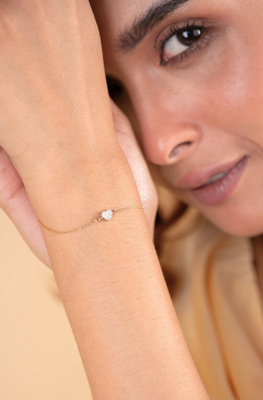 Elevate your everyday style with the 18kt Shining Heart Bracelet crafted with diamond. This delicate and feminine piece is perfect for everyday wear, work attire, and casual looks, making it an ideal gifting idea for her. Priced under Rs. 30,000, this elegant bracelet is a must-have addition to your accessory collection, effortlessly elevating any outfit.