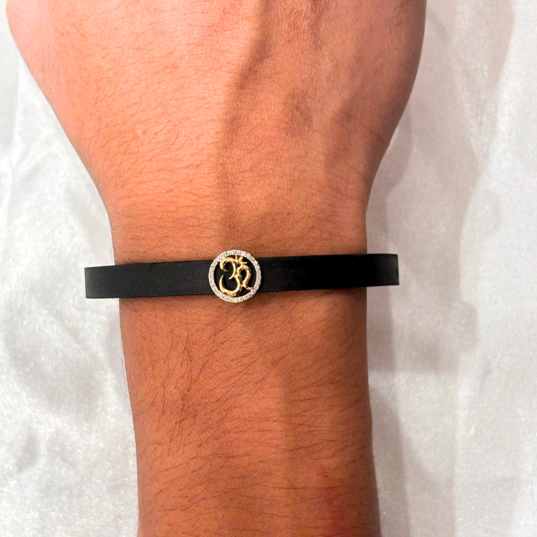 Om Men’s Bracelet in 18kt gold with natural diamonds, featuring a black band and gold Om charm—BIS hallmarked, perfect for gifting under ₹30K.