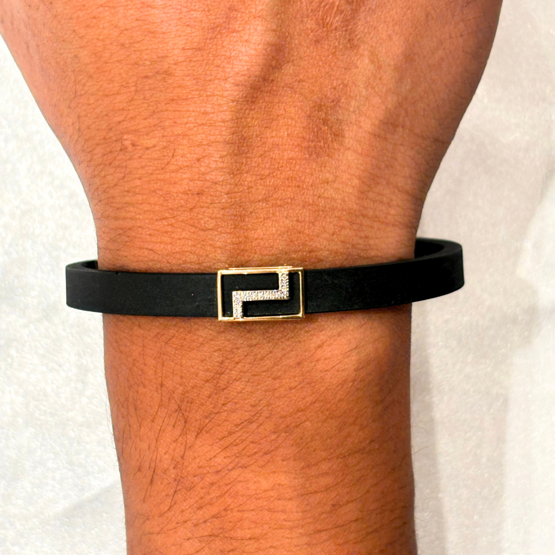 Zigzag-patterned men’s bracelet in 18kt gold with 0.04 ct natural diamond, featuring a sleek black band—crafted for bold, everyday elegance under ₹30K.