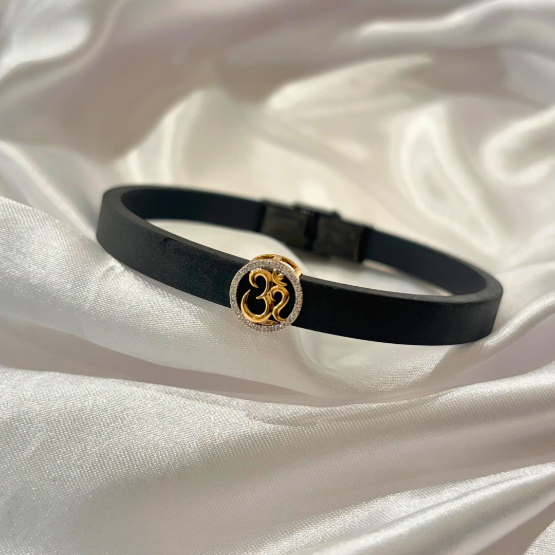 Om Men’s Bracelet in 18kt gold with natural diamonds, featuring a black band and gold Om charm—BIS hallmarked, perfect for gifting under ₹30K.