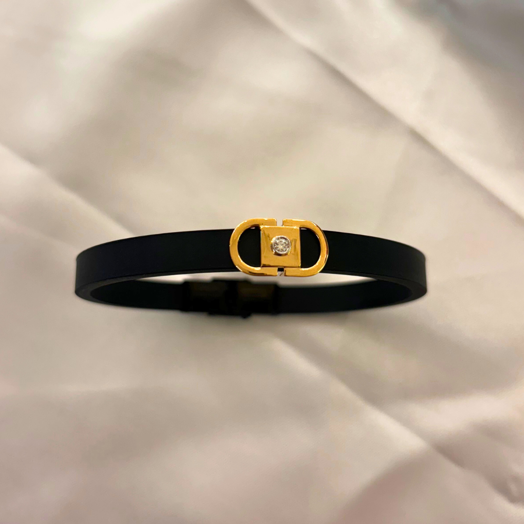 Men’s gold bracelet by Caratly, featuring a sleek black band with a central gold clasp adorned with a natural diamond, blending modern style with classic luxury under Rs. 30,000!