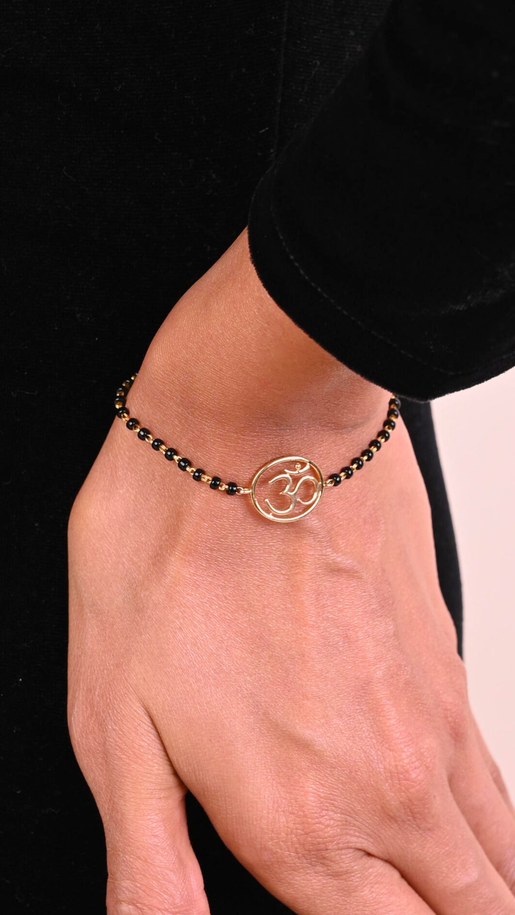 Gold Om Mangalsutra Bracelet in 18kt gold, featuring IGI certified VVS diamonds. Ideal for luxury jewelry gifts under 30k. BIS hallmarked, perfect for everyday wear and special occasions.