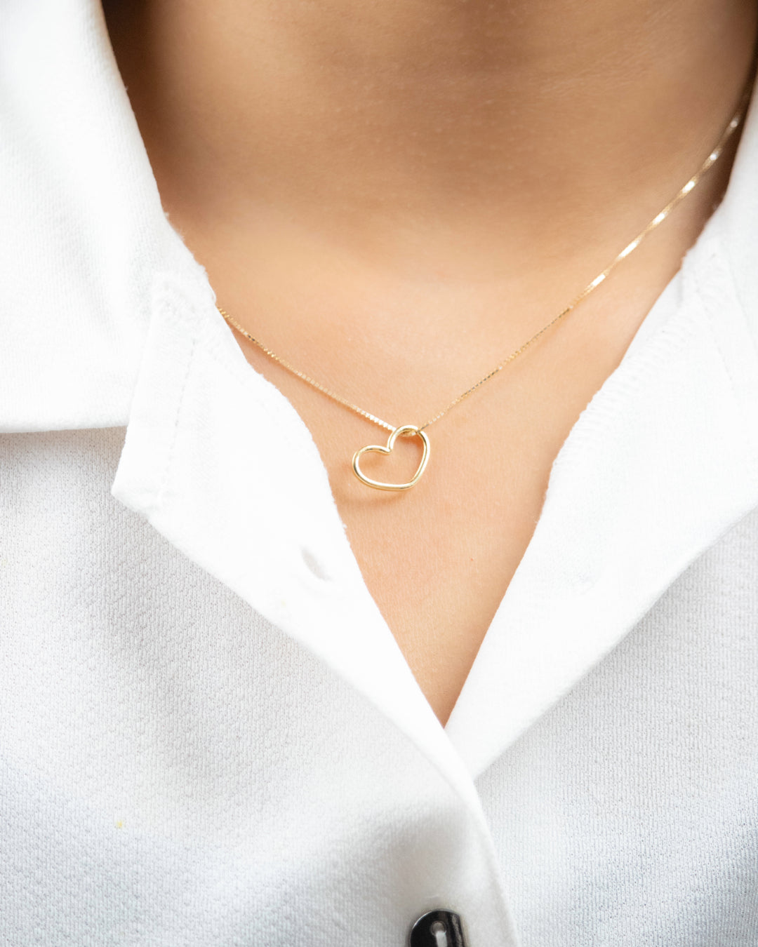 Embrace timeless elegance with our 18 kt Gold Minimal Heart Pendant. This delicate piece features a minimalist heart design, perfect for everyday wear for women. With its lightweight feel and versatile style, it's an ideal addition to your daily wear outfit or a thoughtful gift for her. Explore our affordable collection, all under 10,000, and discover the perfect piece to elevate your look from 9 to 5 and beyond.
