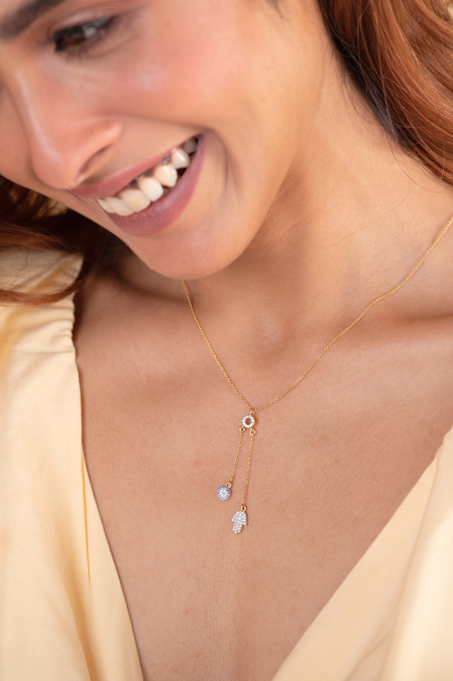 Embrace positivity with the captivating 18 kt Gold Evil Eye Hamsa Necklace for Women. This elegant necklace serves as a versatile accessory for everyday wear, bringing good fortune and protection. Part of our Under 50,000 collection, it makes a thoughtful gift idea for her, effortlessly complementing both casual and work attire for a chic, modern look. Crafted with precision and style, the Hamsa design adds a touch of sophistication to any outfit, symbolizing blessings and warding off negativity.