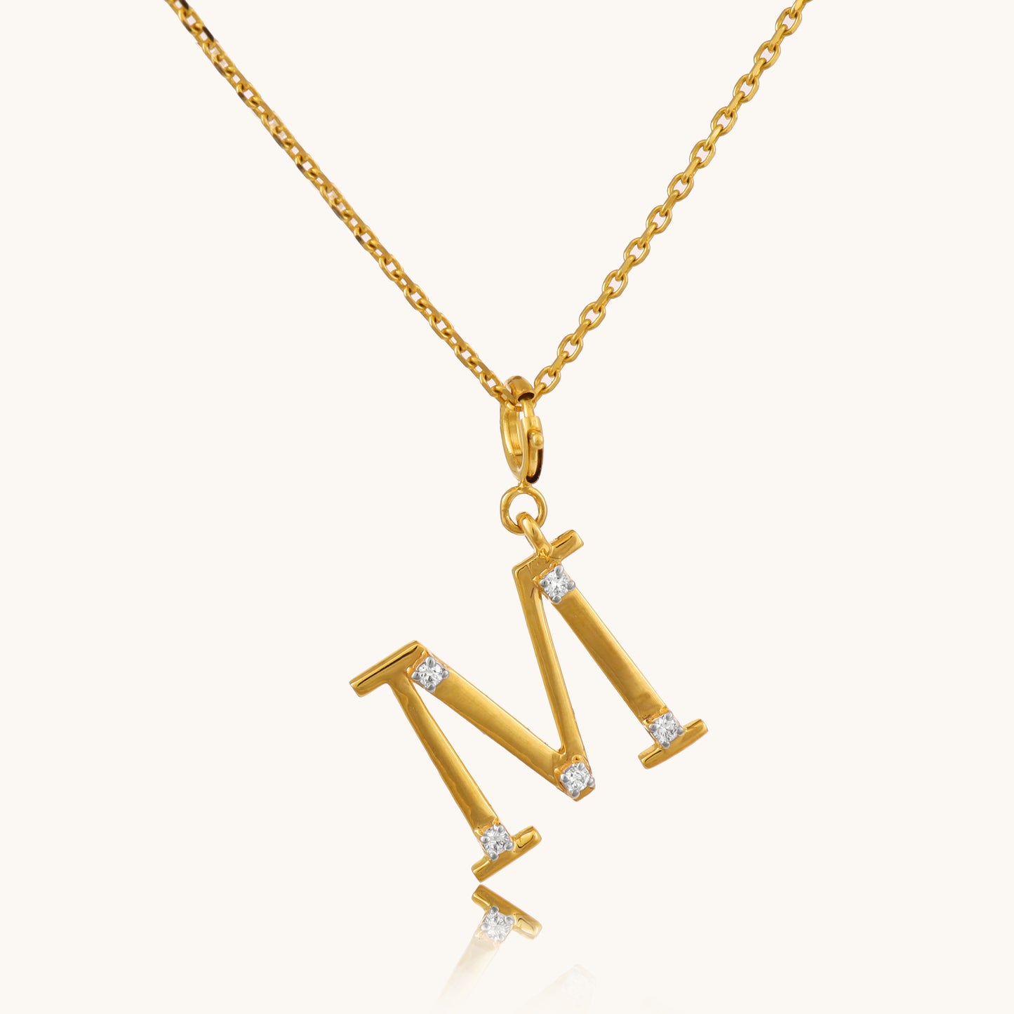 Personalize your style with our exquisite 18kt gold M Diamond Pendant. Adorned with sparkling diamonds in the shape of the letter "M", it adds a touch of personalized luxury to any ensemble. Perfect for special occasions or celebrating a loved one's initial, this pendant is ideal for everyday wear, whether it's for work or evening attire. Treat yourself to this stunning piece, priced under 30,000.