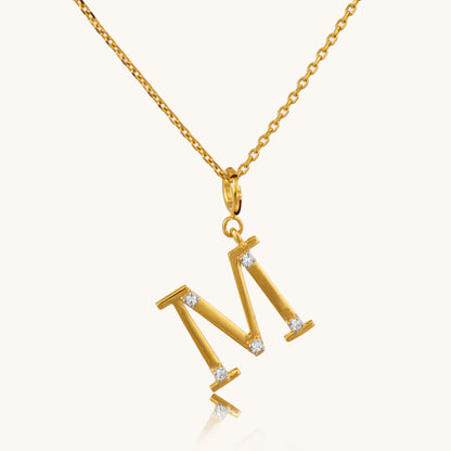 Personalize your style with our exquisite 18kt gold M Diamond Pendant. Adorned with sparkling diamonds in the shape of the letter "M", it adds a touch of personalized luxury to any ensemble. Perfect for special occasions or celebrating a loved one's initial, this pendant is ideal for everyday wear, whether it's for work or evening attire. Treat yourself to this stunning piece, priced under 30,000.