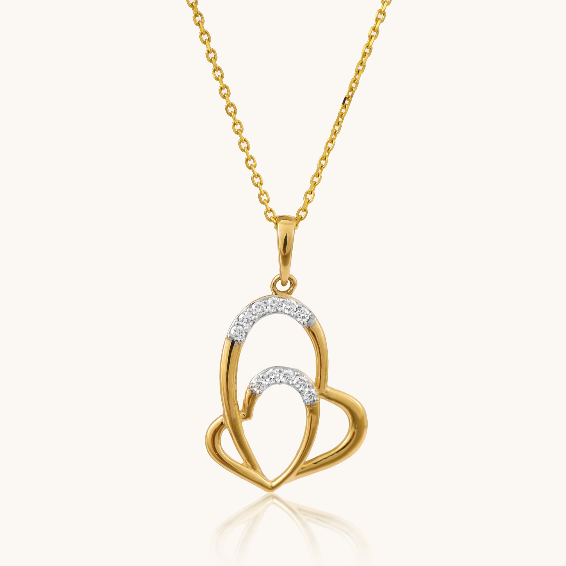 Celebrate love in style with our captivating 18kt gold Interloop Heart Pendant. Featuring two interlocking hearts, this romantic design symbolizes timeless connection and affection. Perfect for everyday wear, it adds elegance to casual looks, workwear, or evening attire. The ideal gift for her under 30,000. 