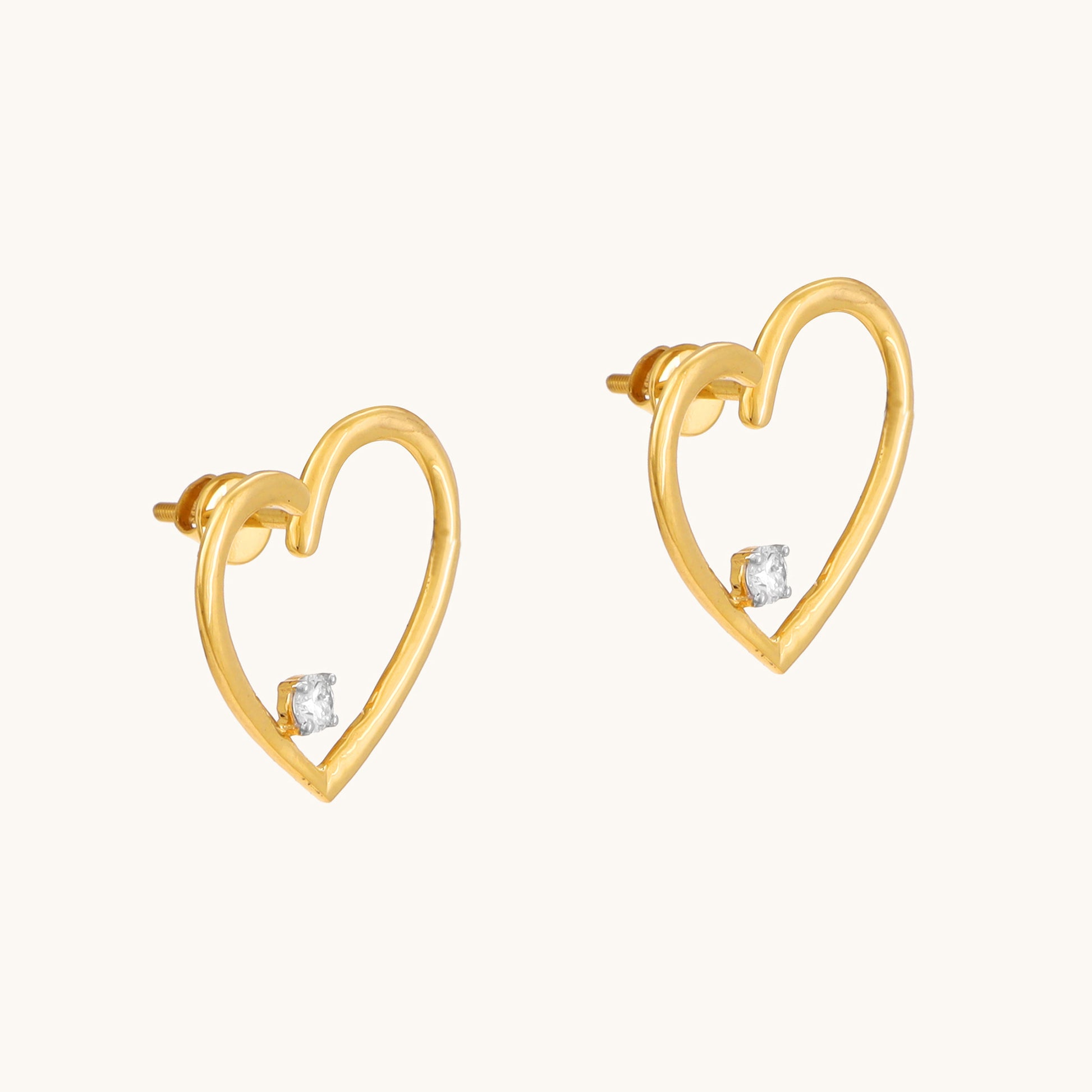 Express your love with the sparkling elegance of the Heart Diamond Earrings crafted in 18kt gold. These earrings add a touch of timeless romance to your everyday look, perfect for casual wear, work attire, or a special occasion. They make a thoughtful gift idea for her all under Rs. 30,000.