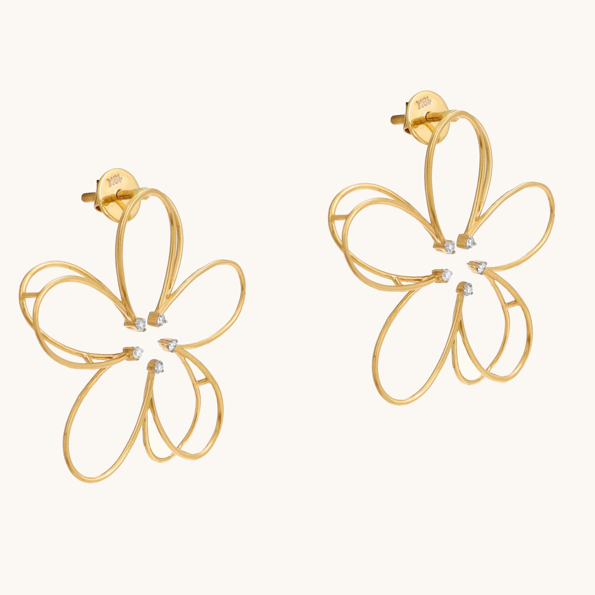 Embrace springtime elegance with the Flower Diamond Earrings, crafted in 18kt gold and featuring sparkling diamonds. These earrings add a touch of floral charm to your everyday look, perfect for casual wear, work attire, or a special occasion. They make a delightful gift for her Under Rs. 50,000. 