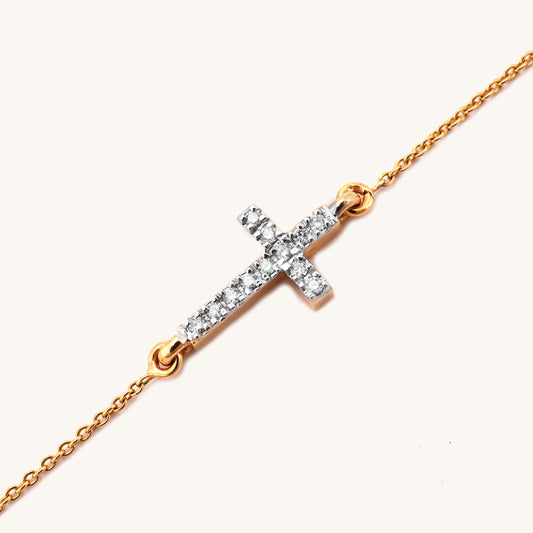 Elevate your style with this exquisite 18Kt gold bracelet featuring a delicate cross design adorned with sparkling diamonds. Crafted with exceptional attention to detail, this stunning piece effortlessly adds a touch of sophistication to any outfit, whether paired with casual or formal attire. Priced affordably under Rs. 30,000, this bracelet makes for a thoughtful and valuable gift for any occasion.