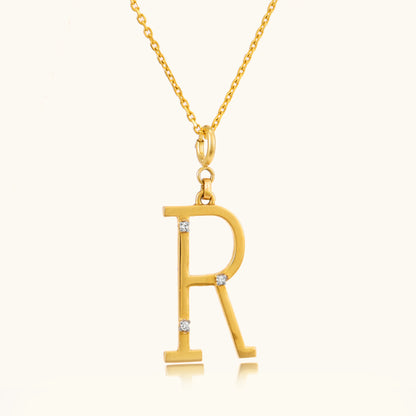 Add a personal touch to your style with our elegant 18 kt gold Letter R Pendant. Perfect for everyday wear, workwear, or evening attire, this pendant adds a unique sparkle to any outfit. Whether it's a gift for someone special or a treat for yourself, it's priced under 10,000. Explore our Under 10,000 collection and find your perfect letter.