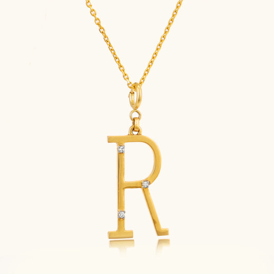 Add a personal touch to your style with our elegant 18 kt gold Letter R Pendant. Perfect for everyday wear, workwear, or evening attire, this pendant adds a unique sparkle to any outfit. Whether it's a gift for someone special or a treat for yourself, it's priced under 10,000. Explore our Under 10,000 collection and find your perfect letter.