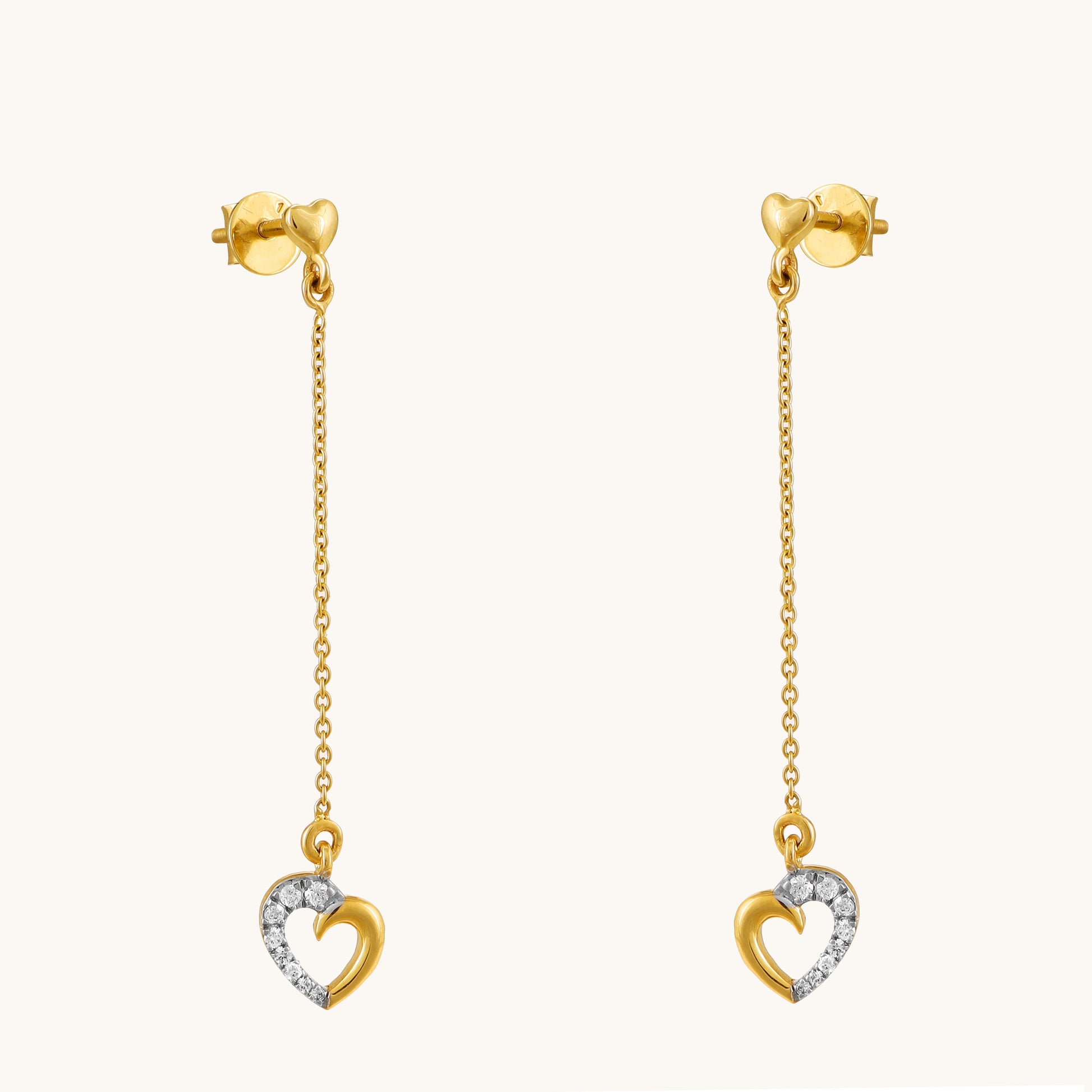 Express your love with the Dropping Heart Earrings. These delicate 18kt gold earrings feature sparkling diamonds and a charming heart design, perfect for everyday wear or adding a touch of romance to work or casual attire. A thoughtful gift idea for her at an affordable price range from our Under 30,000 collection.