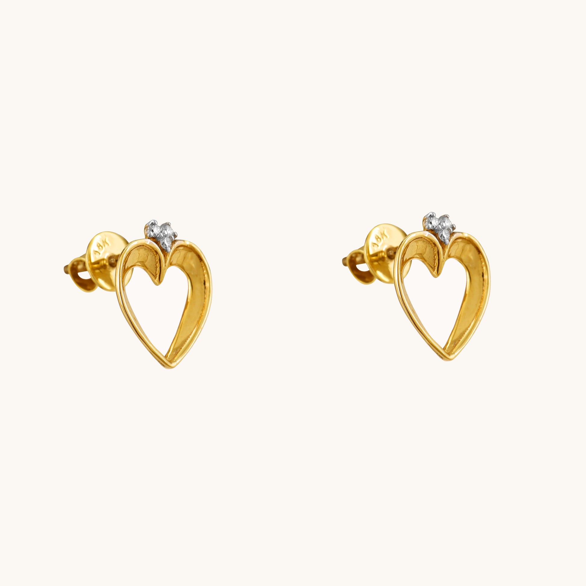 Show your love with a touch of understated elegance. These Lining Heart Earrings, crafted in 18kt gold and featuring a delicate heart design, are perfect for everyday wear. They're versatile enough for casual looks, work attire, or special occasions. A thoughtful and affordable gift idea for her under Rs. 30,000.