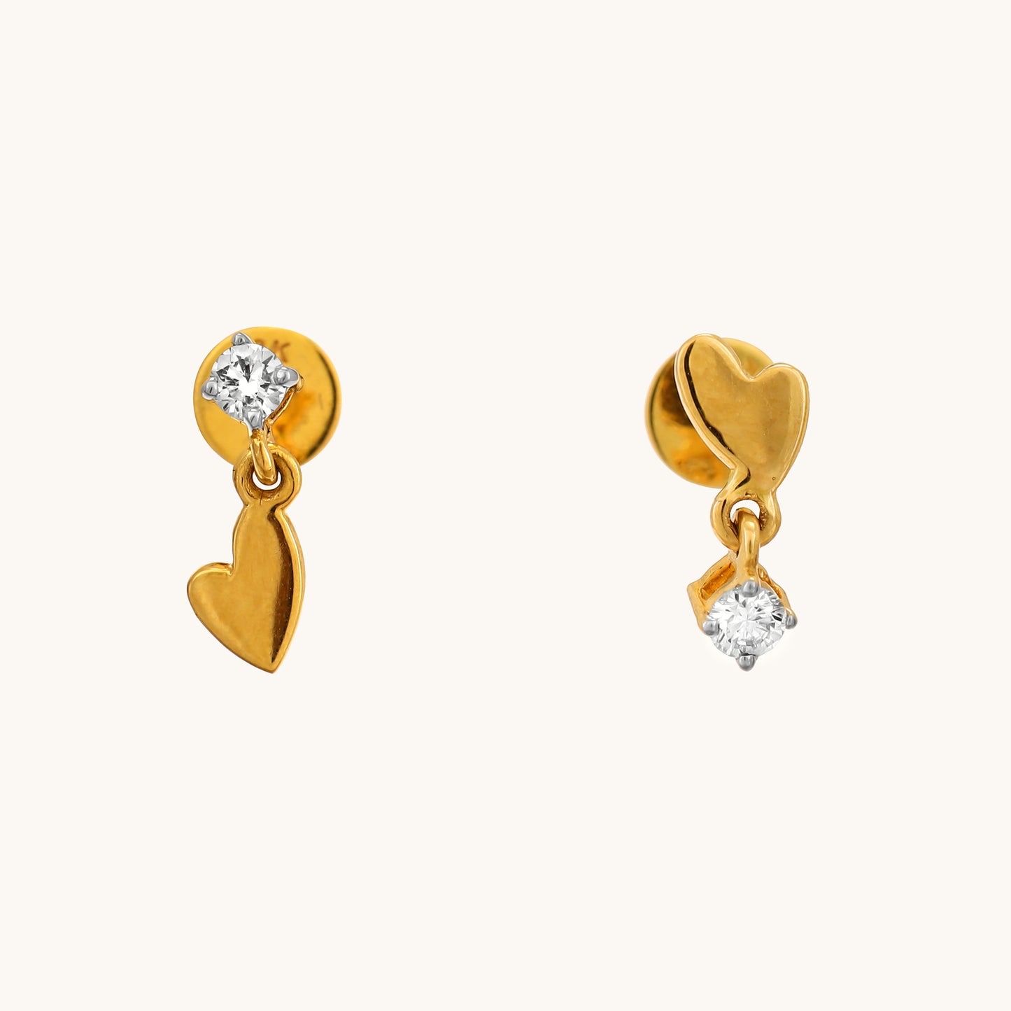 Elevate your style with our Spring Edit, featuring captivating 18 kt Dangling Heart Earrings. This stunning jewellery piece effortlessly transitions from day to night, adding a touch of elegance to any ensemble. Priced under Rs. 30,000, it's a chic addition to any outfit and an ideal gifting option for her. 