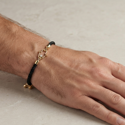 Black rope men's diamond bracelet with an 18kt gold hand amulet charm and diamond accent. A perfect gold gift for him under Rs. 15,000