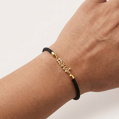 Black cord men's diamond bracelet featuring an 18kt gold '#BHAI' charm with sparkling diamond accents. A perfect minimal gift for brother under Rs. 20,000