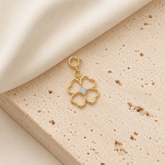 Gold four-petal clover pendant outlined in gold with a diamond-set centre. Minimal gifts for her under Rs. 15,000