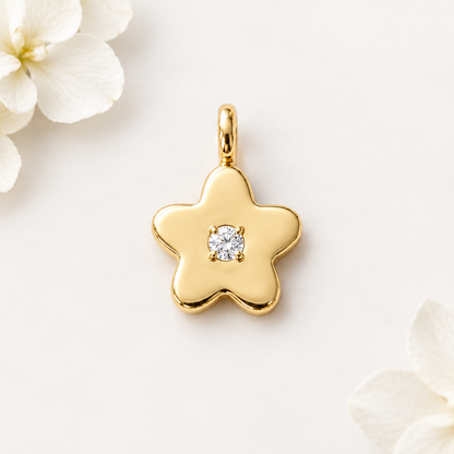 Gold star-shaped flower pendant set with a single sparkling diamond, priced under Rs. 25,000
