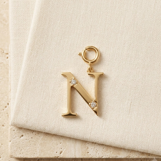 Gold letter N pendant with diamond accents along the stroke under Rs. 20,000