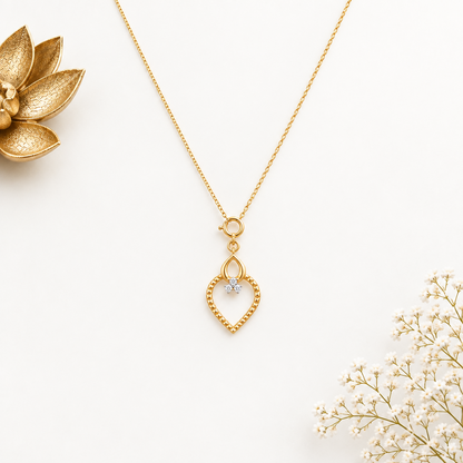 Gold textured heart-shaped pendant with a teardrop top and a diamond cluster accent priced under Rs. 20,000