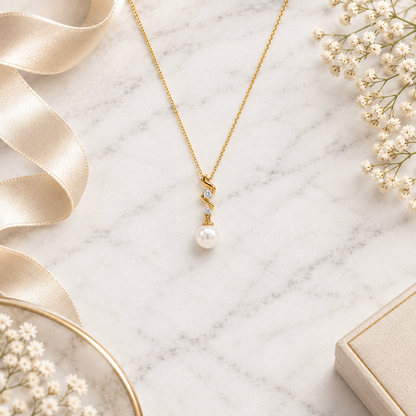 Gold swirled pendant set with two diamonds above a large lustrous pearl drop priced under Rs. 20,000