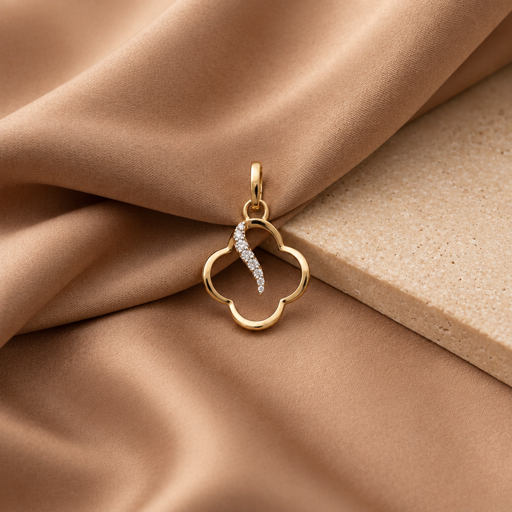 Gold clover-shaped pendant with a diamond-set swirl detail priced under Rs. 20,000