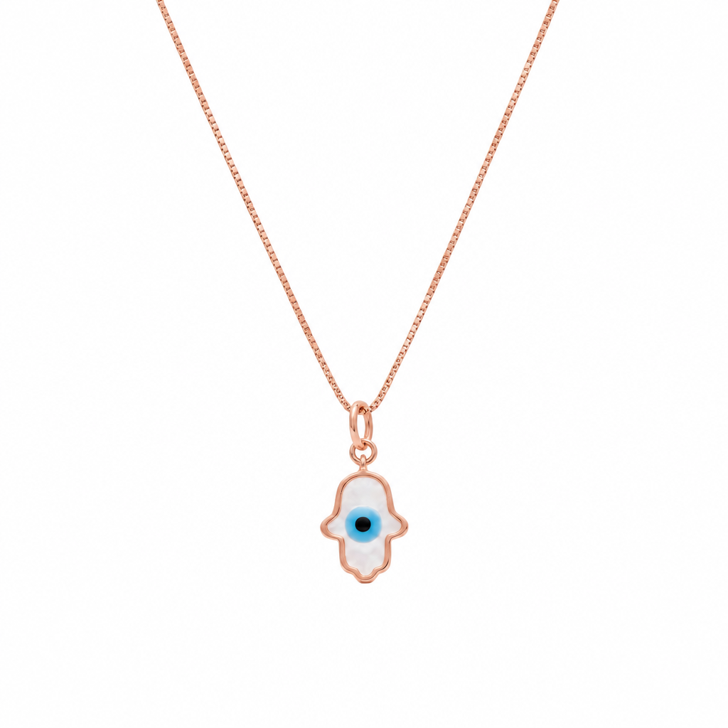 Gold hamsa hand pendant outlined in white enamel with a blue evil eye center. Protective gifts for her under Ra, 15,000