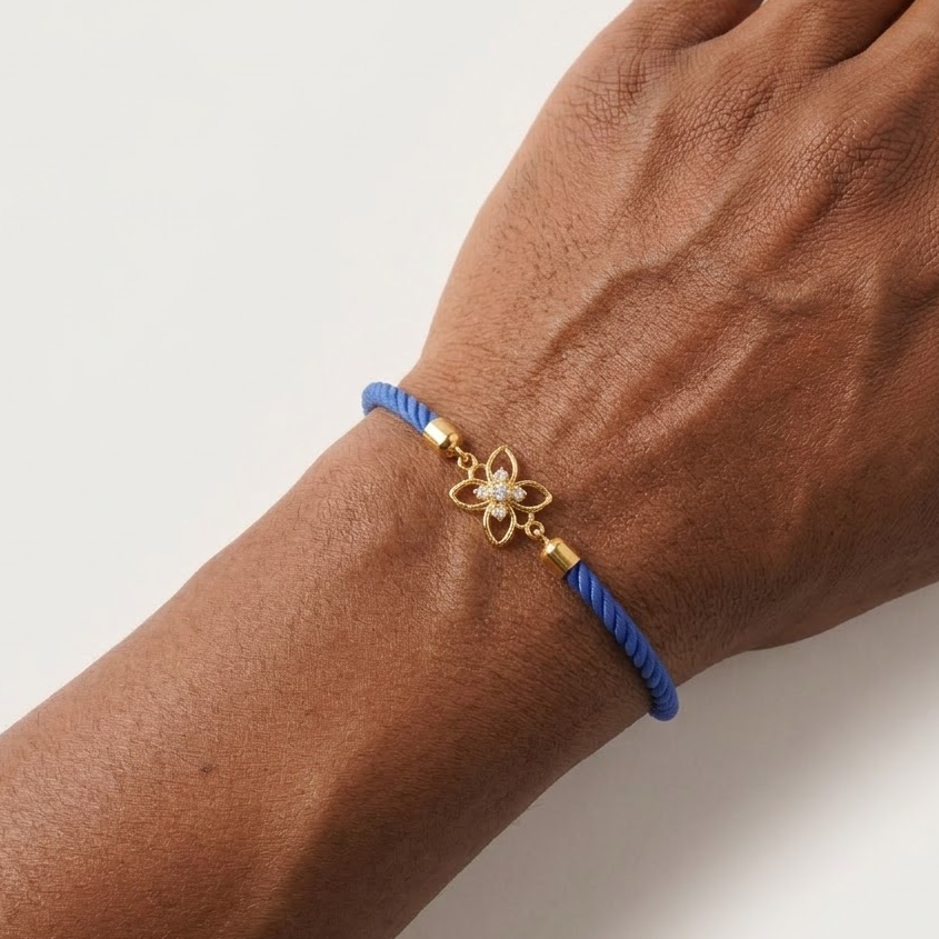 Blue rope men's diamond bracelet with an 18kt gold floral charm and sparkling diamond center under Rs. 15,000