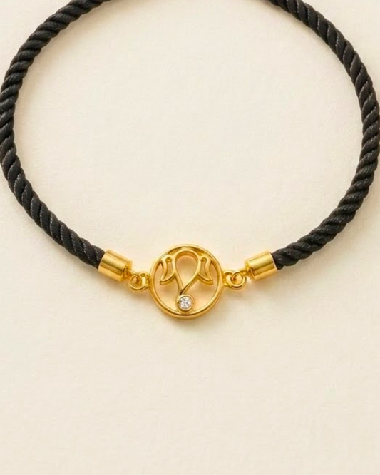 Sleek black braided cord Ganesha Bracelet centered with a polished 18kt gold deity motif and a sparkling diamond. A perfect gift for him under Rs. 20,000