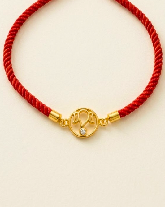 Vibrant red cord Ganpati Bracelet featuring a central 18kt gold motif accented with a delicate diamond. Gift men's bracelet under Rs. 20,000