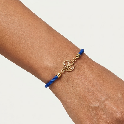 Blue rope men's bracelet with an 18kt gold Hanuman Ji pendant and diamond accents, on white background. Gift for him under Rs. 15,000