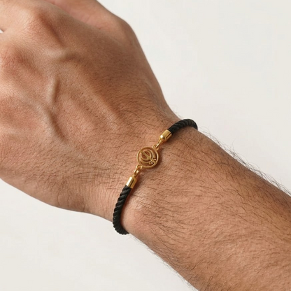 Black rope men's gold bracelet featuring an 18kt gold Khanda symbol charm pendant. A perfect gold gift for him at Rs. 10,000