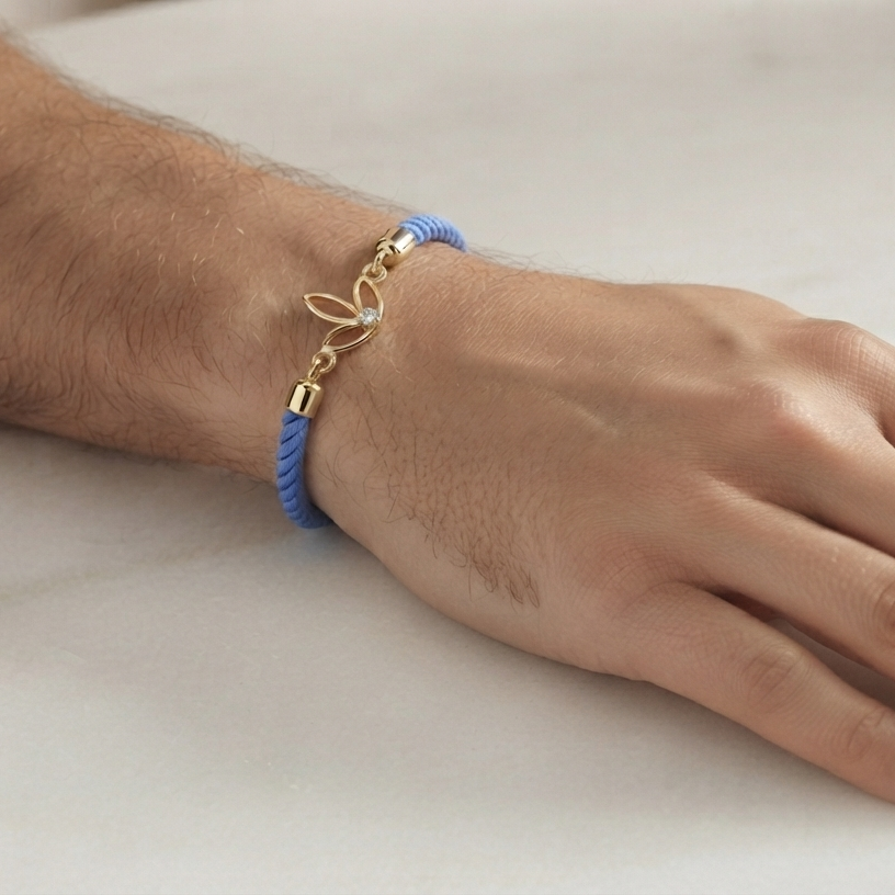 Blue rope men's bracelet with an 18kt gold leaf charm and sparkling diamond accent. A perfect minimal gift for him under Rs. 15,000
