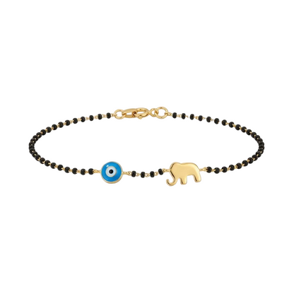 Black bead bracelet with a blue evil eye bead and a gold elephant charm. Minimal and cute gift for kids under Rs. 50,000