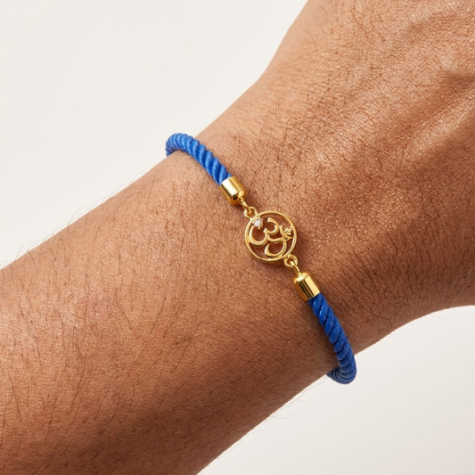 Blue rope men's bracelet with 18kt gold Om charm and diamond accent. An affordable gift for him under Rs. 15,000