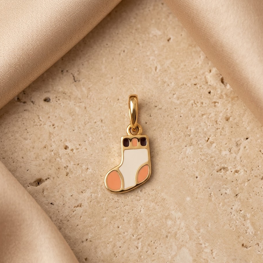 Gold pendant shaped like a colorful striped sock. A cute and minimal gift for kids under Rs. 15,000
