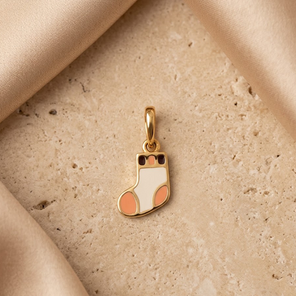 Gold pendant shaped like a colorful striped sock. A cute and minimal gift for kids under Rs. 15,000