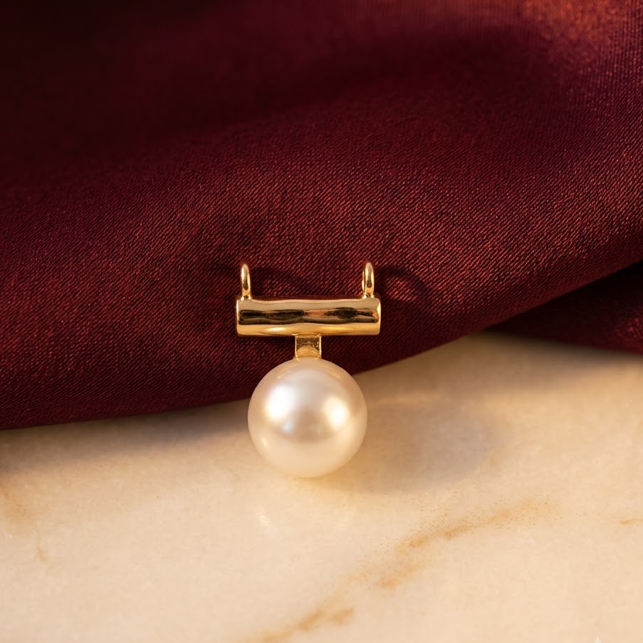 Gold bar-style pendant holding a large lustrous white pearl priced under Rs. 20,000