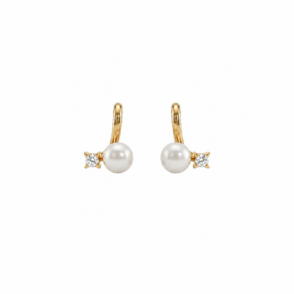Gold huggie earrings with a white pearl drop and a diamond baguette accent, priced under Rs. 20,000