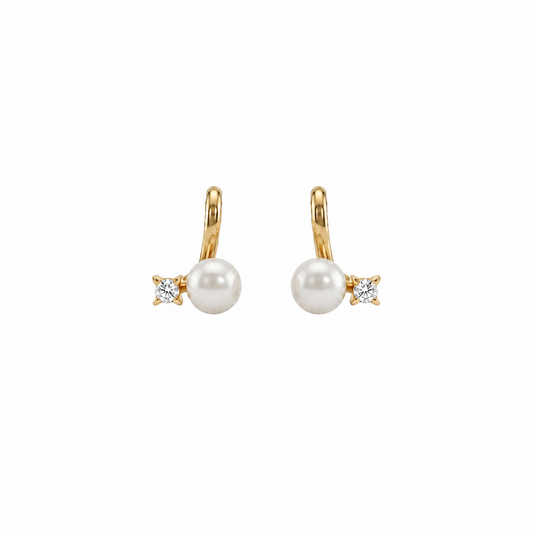 Gold huggie earrings with a white pearl drop and a diamond baguette accent, priced under Rs. 20,000