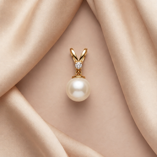 Gold V-bail pendant holding a large lustrous pearl beneath a sparkling diamond accent, priced under Rs. 20,000
