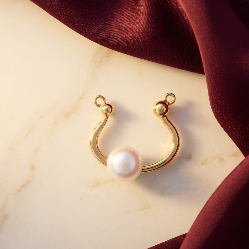 Gold curved open pendant with a smooth wrap design and a lustrous white pearl at one end priced under Rs. 23,000