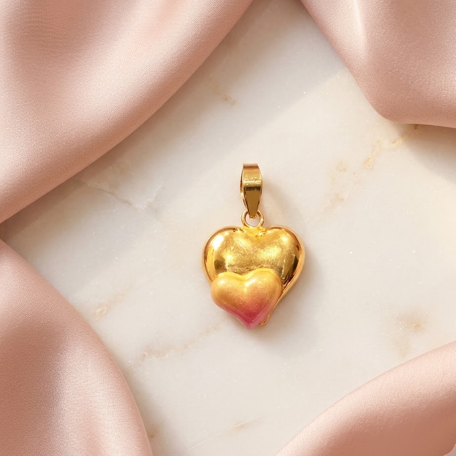 Gold puffed heart pendant with a pink enamel gradient at the base