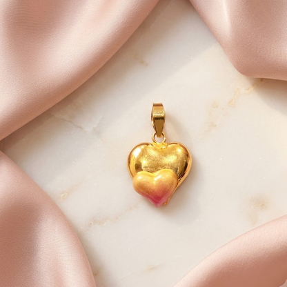 Gold puffed heart pendant with a pink enamel gradient at the base