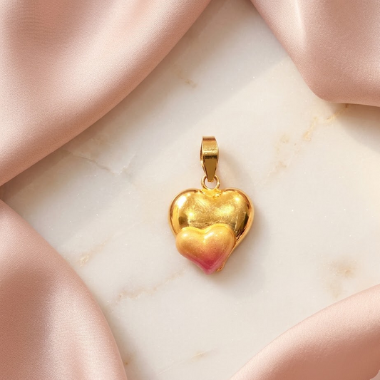 Gold puffed heart pendant with a pink enamel gradient at the base