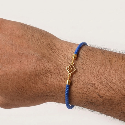 Blue rope men's gold bracelet with an 18kt gold square pattern geometric charm design. An affordable gifting option for Men's under Rs. 10,000